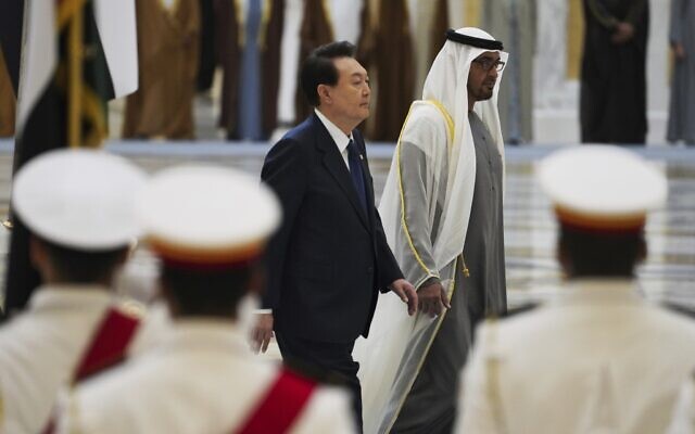 South Korean President Yoon Suk Yeol, center left, and Emirati leader Sheikh Mohammed bin Zayed Al Nahyan walk past an honor guard at Qasar Al Watan in Abu Dhabi, United Arab Emirates, Jan. 15, 2023. (AP Photo/Jon Gambrell)