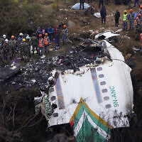 Rescuers scour the crash site in the wreckage of a passenger plane in Pokhara, Nepal, Monday, Jan.16, 2023..(AP Photo/Yunish Gurung)