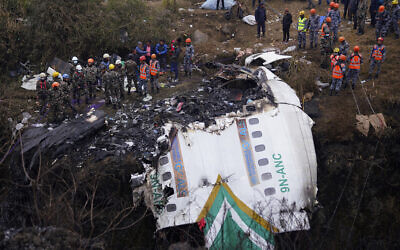 Rescuers scour the crash site in the wreckage of a passenger plane in Pokhara, Nepal, Monday, Jan.16, 2023..(AP Photo/Yunish Gurung)