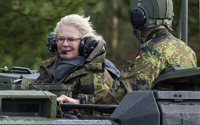 German Defense Minister Christine Lambrecht rides in a tank during her visit to the Tank Training Brigade 9 in Munster, Germany, February 7, 2022. (Philipp Schulze/dpa via AP, File)