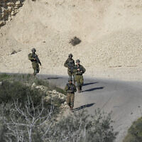 Soldiers patrol the scene after a Palestinian was shot and killed following an alleged attempted attack on an Israeli, next to Sde Efraim farm in the West Bank, Saturday, January 21, 2023. (AP Photo/Mahmoud Illean)