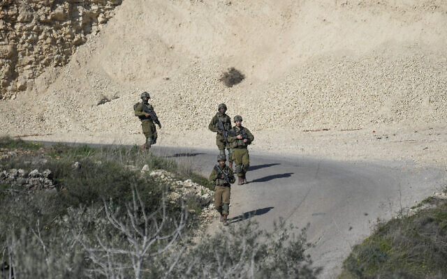 Soldiers patrol the scene after a Palestinian was shot and killed following an alleged attempted attack on an Israeli, next to Sde Efraim farm in the West Bank, Saturday, Jan. 21, 2023. (AP Photo/Mahmoud Illean)