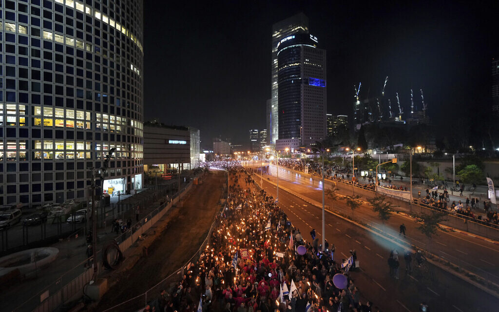 People march in a protest against Prime Minister Benjamin Netanyahu and his his far-right government that his opponents say threaten democracy and freedoms, in Tel Aviv, Israel, January 21, 2023. (AP Photo/Tsafrir Abayov)
