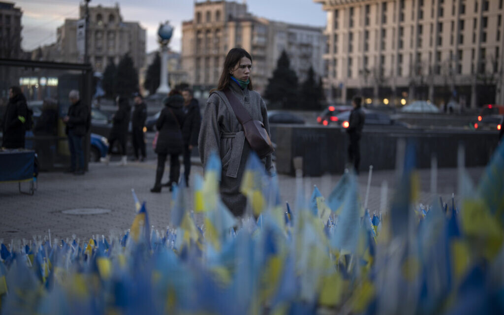 Illustrative: A woman stops to look at Ukrainian flags placed in memory of those killed during the war near Maidan Square in central Kyiv, Ukraine,  January 20, 2023. (Daniel Cole/AP)