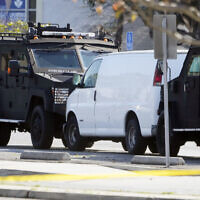 A van is surrounded by SWAT personnel in Torrance Calif., Sunday, Jan. 22, 2023. (AP Photo/Damian Dovarganes)