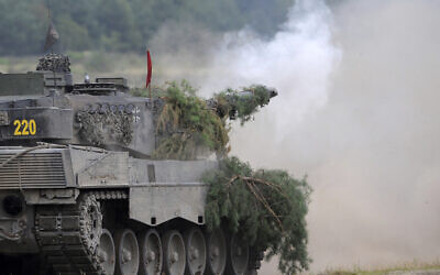 A Leopard 2A6 tank from the Bundeswehr's Panzer exercise bataillon 93 fires at the Oberlausitz training area in Weisskeissel, Germany, August 12, 2009. (Ralf Hirschberger/dpa via AP, file)