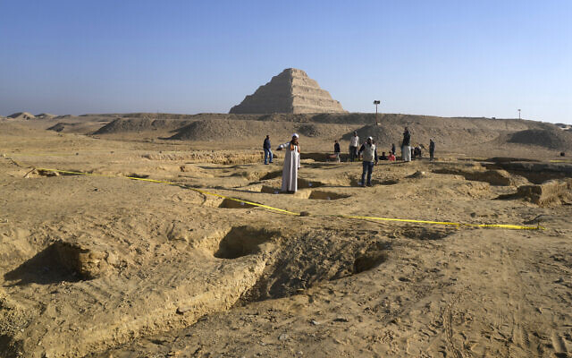 Egyptian antiquities workers dig at the site of the Step Pyramid of Djoser in Saqqara, southwest of Cairo, Egypt, January 26, 2023. (Amr Nabil/AP)