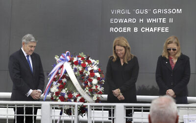 From left, Bob Cabana, Associate Administrator of NASA; Sheryl Chaffee, daughter of Apollo 1 astronaut Roger Chaffee, and Janet Petro, NASA KSC director, bow their heads in prayer during NASA's Day of Remembrance ceremony, hosted by the Astronauts Memorial Foundation at Kennedy Space Center Visitor Complex, Thursday, January 26, 2023. (Joe Burbank/Orlando Sentinel via AP)