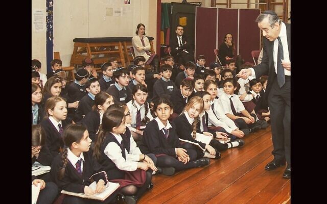 Rabbi Abraham Levy speaks to students at Naima Jewish Preparatory School, which he founded, in the early 2010s. (Courtesy of Rabbi Joseph Dweck via JTA)