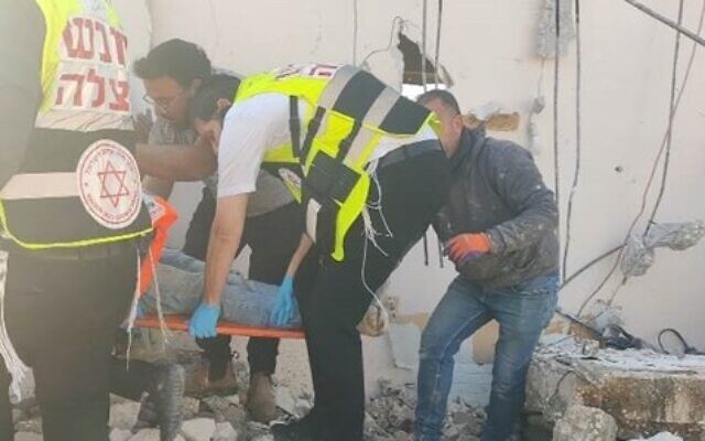 Medics attend to a construction worker who was fatally injured at a site in Bnei Brak, January 26, 2022. (Hatzolah)