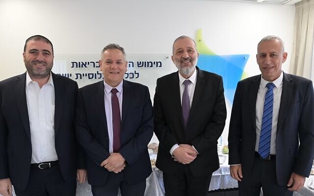 Left to right: Deputy Health Minister Moshe Arbel, outgoing health minister Nitzan Horowitz, Health Minister Aryeh Deri, and outgoing health ministry director-general Nachman Ash at a handover ceremony at the ministry, January 1, 2023. (GPO)