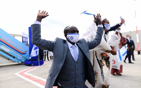 A member of the Ethiopian community celebrates upon arriving at Ben Gurion airport on March 11, 2021. (Tomer Neuberg/Flash90)