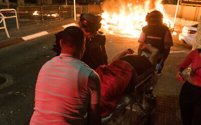 Medics evacuate Mor Ganashvili, injured during a mob attack amid clashes between Arab and Jews in Acre, northern Israel, May 12, 2021. (Roni Ofer/Flash90)