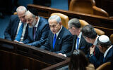 Prime Minister Benjamin Netanyahu (C), Justice Minister Yariv Levin (3rd-R) and other ministers sit in the Knesset after the swearing-in ceremony of the new government, December 29, 2022. (Yonatan Sindel/Flash90)