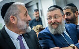 Yoav Ben-Tzur, acting health minister (right), with Aryeh Deri at the Ministry of Social Affairs, Jerusalem, on January 1, 2023. (Yonatan Sindel/Flash90)