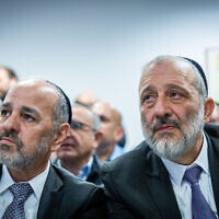 Shas's Ya'akov Margi (L) with party leader Aryeh Deri in Jerusalem on January 1, 2023 (Yonatan Sindel/Flash90)