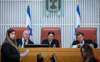 Supreme Court President Esther Hayut (center), Justice Uzi Vogelman (left) and Justice Isaac Amit (right) at a hearing of the High Court of Justice on petitions against the appointment of Shas party leader Aryeh Deri as a minister due to his recent conviction for tax offenses, January 5, 2023. (Yonatan Sindel/Flash90)