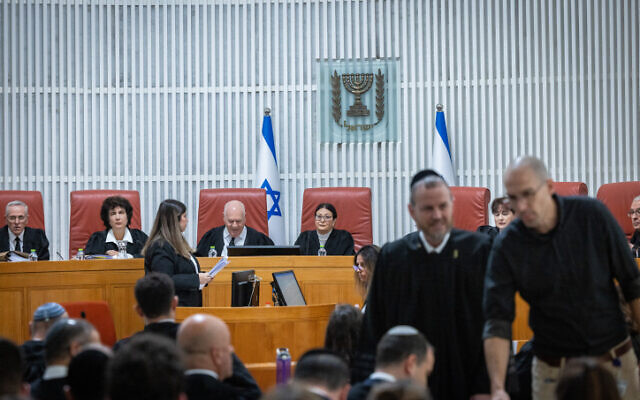 President of the Supreme Court Esther Hayut (center) and colleagues hold a hearing on petitions demanding they block the return of Shas leader Aryeh Deri as a minister due to his recent conviction and suspended sentence for tax offenses, at the High Court in Jerusalem, January 5, 2023. (Yonatan Sindel/Flash90)