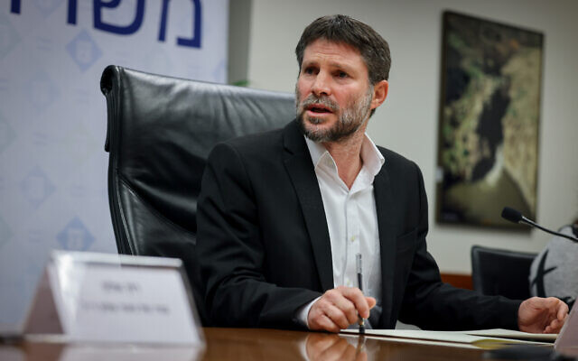 Finance Minister Bezalel Smotrich holds a press conference with bereaved families at the Finance Ministry in Jerusalem, January 8, 2023. (Yonatan Sindel/Flash90)