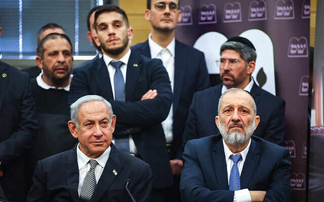 Shas leader Aryeh Deri (right) and Prime Minister Benjamin Netanyahu attend a Shas party faction meeting at the Knesset in Jerusalem, on January 23, 2023. (Yonatan Sindel/Flash90)