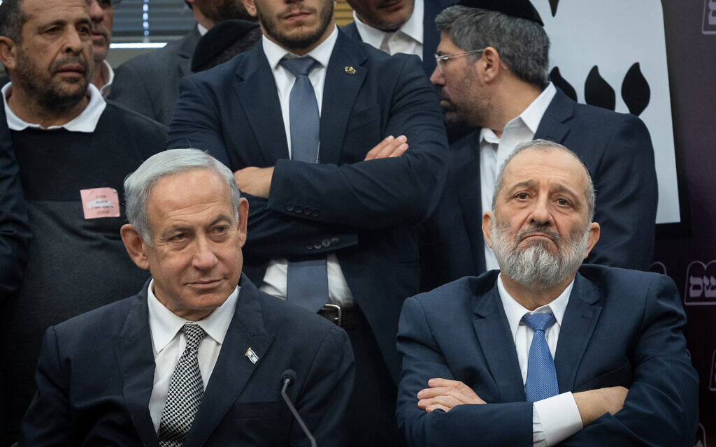 Shas leader MK Aryeh Deri, right, and Prime Minister Benjamin Netanyahu seen during a Shas party meeting at the Knesset in Jerusalem on January 23, 2023. (Yonatan Sindel/Flash90)