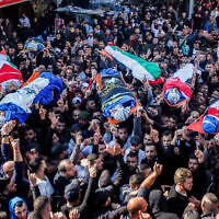 Mourners carry the bodies of Palestinians who were killed by Israeli security forces during an operation, in the West Bank city of Jenin on January 26, 2023.  (Nasser Ishtayeh/Flash90)