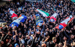 Mourners carry the bodies of Palestinians who were killed by Israeli security forces during an operation, in the West Bank city of Jenin on January 26, 2023.  (Nasser Ishtayeh/Flash90)