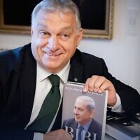 Hungarian Prime Minister Viktor Orban holds a copy of Prime Minister Benjamin Netanyahu's memoir on November 3, 2022. (Viktor Orban/Twitter)