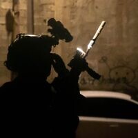Illustrative: An IDF soldier is seen with night-vision equipment during a raid in the West Bank, early January 13, 2023. (Israel Defense Forces)