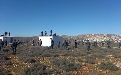 Security forces move in to evacuate an illegal settlement outpost established in the West Bank on January 20, 2023. (Courtesy)