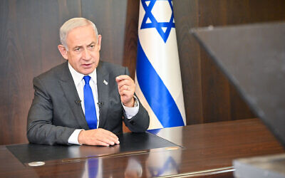 Prime Minister Benjamin Netanyahu holds a video conversation with members of AIPAC from his office in Jerusalem on January 9, 2023. (Kobi Gideon/GPO)