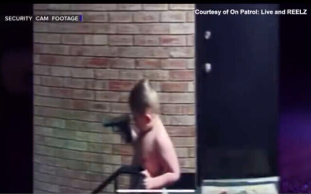 A young boy in Indiana seen playing with a handgun in security camera footage. (Twitter screenshot/used in accordance with Clause 27a of the Copyright Law)