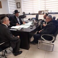 Deputy Minister Avi Maoz, right, meets with Ashkenazi Chief Rabbi David Lau, center-left, in the latter's office in Jerusalem on January 11, 2023. (Avi Maoz's Office)
