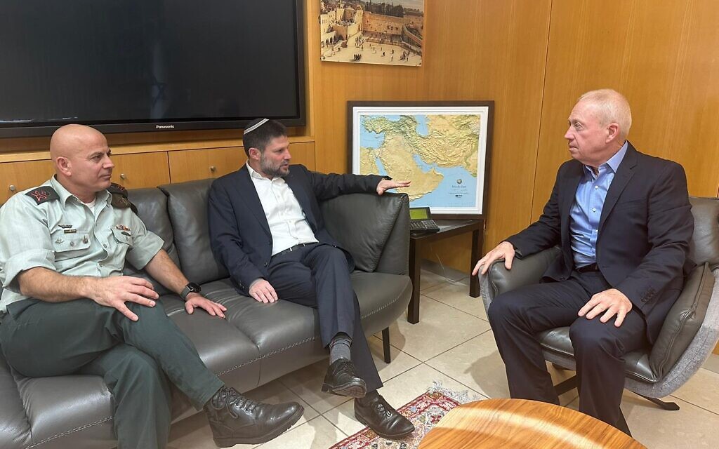 Finance Minister Bezalel Smotrich (center), Defense Minister Yoav Gallant (right), and COGAT head Maj. Gen. Ghassan Alian (left) hold a meeting at the Defense Ministry in Tel Aviv, January 12, 2023. (Courtesy)