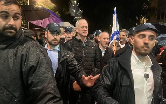National Unity leader MK Benny Gantz arrives at an anti-government protest in Tel Aviv, on January 14, 2023. (Naomi Lanzkron/Times of Israel)