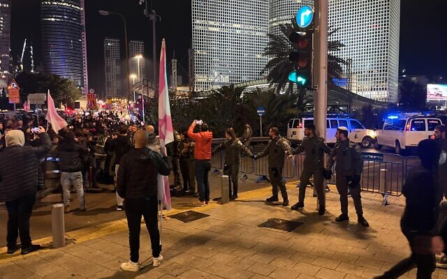 Police block off the entrance to the Ayalon Highway in Tel Aviv amid an anti-government rally, January 14, 2023. (Naomi Lanzkron/Times of Israel)