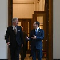 President Isaac Herzog (R) and Philippe, King of the Belgians, walk into the king's private office in the Royal Palace of Brussels, January 25, 2023 (Haim Zach/GPO)