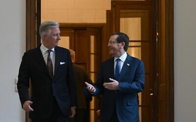 President Isaac Herzog (R) and Philippe, King of the Belgians, walk into the king's private office in the Royal Palace of Brussels, January 25, 2023 (Haim Zach/GPO)