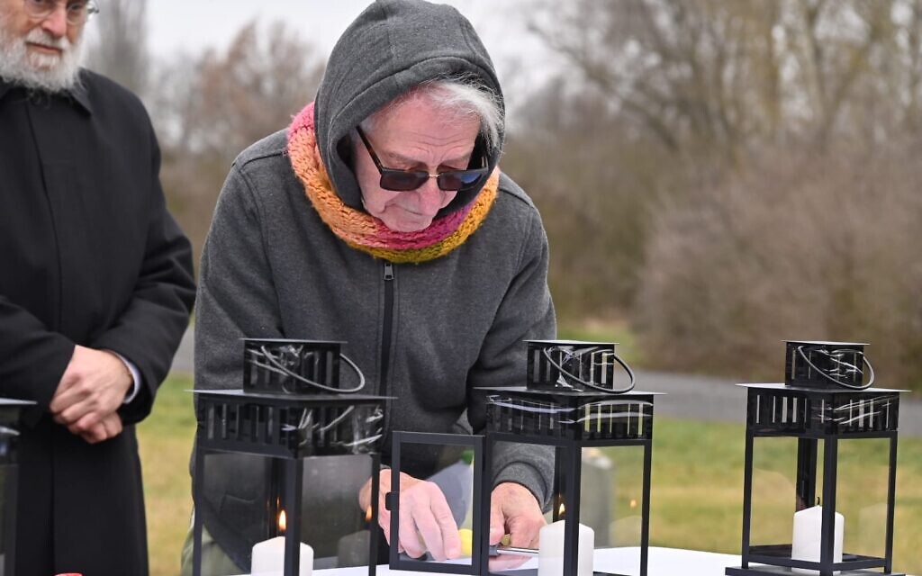 Holocaust survivor Gidon Lev lights a memorial candle at the former Theresienstadt ghetto-concentration camp, pictured on January 24, 2023. (Courtesy EJA)