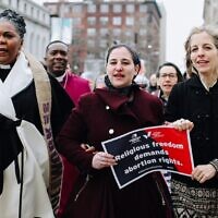 From left to right: Rev. Traci Blackmon, Maharat Rori Picker Neiss and Americans United for Separation of Church & State CEO Rachel Laser march to the Civil Courts building in St. Louis. (Courtesy of Americans United for Separation of Church & State via JTA)