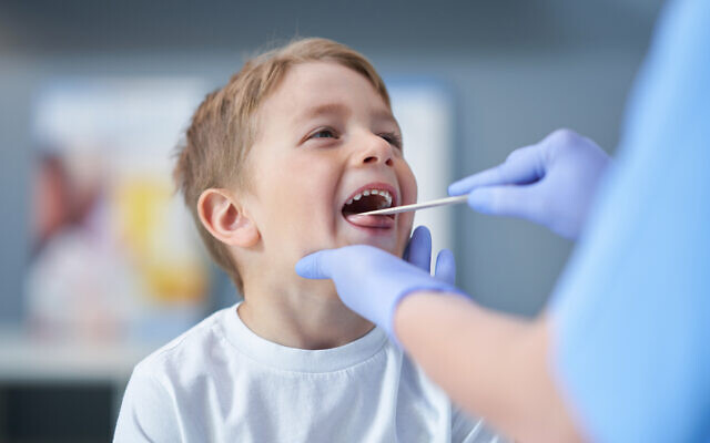 Illustrative: A child gets examined by a doctor for strep (macniak via iStock by Getty Images)
