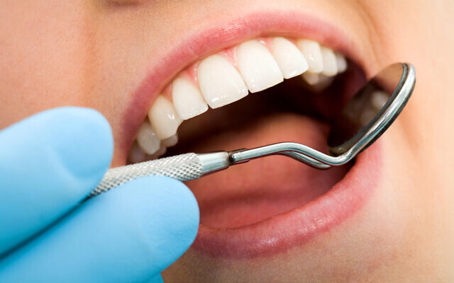 A woman undergoing a dental checkup (shironosov via iStock by Getty Images)