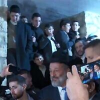 Shas leader Aryeh Deri is greeted by supporters as he emerges from his home in Jerusalem on January 18, 2023. (Video screenshot)