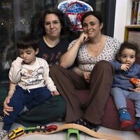 Yael Rashlin (R) a transgender woman, poses for a photo with her partner Hadar and and their children Yarden and Hillel, at their home in the town of Tzur Hadassah in central Israel, on December 1, 2022. (MENAHEM KAHANA / AFP)