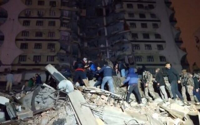 In this video grab from AFP TV taken on February 6, 2023, rescuers search for victims of a 7.8-magnitude earthquake that hit Diyarbakir, in southeastern Turkey. (Mahmut BOZARSLAN/AFPTV/AFP)
