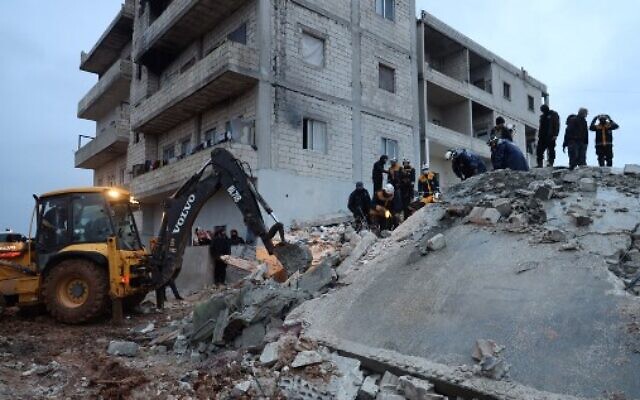 Members of the Syrian Civil Defence, or White Helmets, look for casualties under the rubble following an earthquake in the town of Zardana in the countryside of the northwestern Syrian Idlib province, February 6, 2023. (Mohammed AL-RIFAI/AFP)