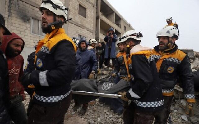 Members of the Syrian Civil Defence, or White Helmets, transport a casualty pulled from the rubble following an earthquake in the town of Zardana in the countryside of the northwestern Syrian Idlib province, February 6, 2023. (Abdulaziz KETAZ/AFP)
