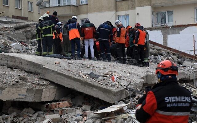 Rescuers search for victims and survivors in the rubble of collapsed buildings in Gaziantep, close to the quake's epicenter, a day after a 7.8-magnitude earthquake struck the country's southeast, on February 7, 2023. (Zein Al Rifai/AFP)