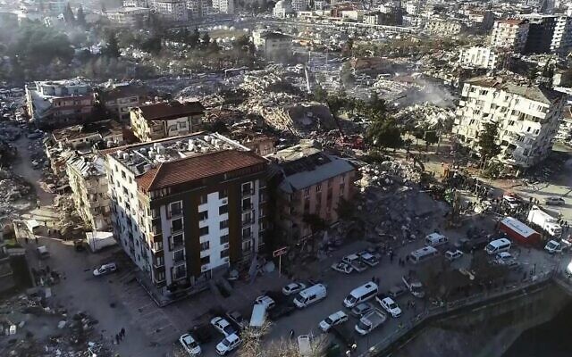 This aerial view shows a collapsed building during ongoing searches in Hatay, southeastern Turkey, on February 9, 2023, two days after a strong earthquake struck the region. (DHA/Demiroren News Agency/AFP)