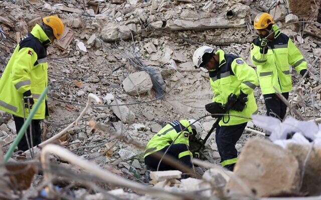 Emirati rescuers continue their search and rescue operations in the regime-controlled town of Jableh in the province of Latakia, northwest of the Syrian capital, on February 12 2023, following a deadly earthquake. (Karim Sahib/AFP)